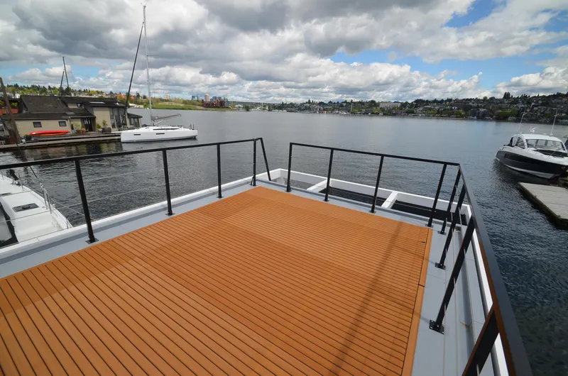  Yacht Photos Pics Rooftop deck of 2024 La Mare Modern 11 houseboat overlooking serene lake and marina.