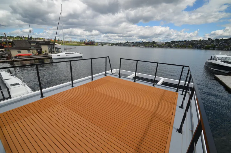  Yacht Photos Pics Rooftop deck of 2024 La Mare Modern 11 houseboat overlooking serene marina.