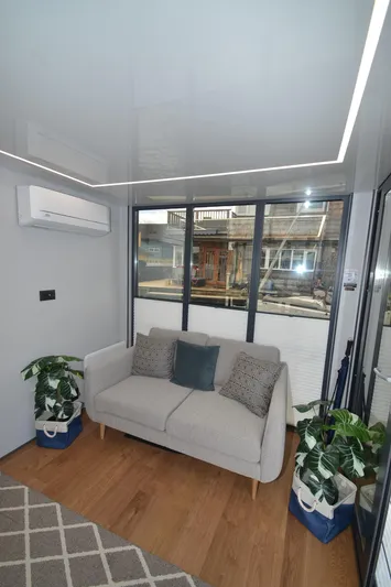  Yacht Photos Pics Modern 2024 La Mare Modern 11 interior with cozy sofa, plants, and large windows.