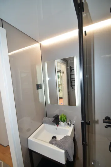  Yacht Photos Pics Modern bathroom in 2024 La Mare Modern 11, featuring sleek sink and mirror design.