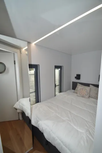  Yacht Photos Pics Compact bedroom in 2024 La Mare Modern 11 houseboat with cozy bed and minimalist decor.