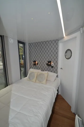  Yacht Photos Pics Compact bedroom in 2024 La Mare Modern 11 houseboat with stylish decor and cozy bedding.