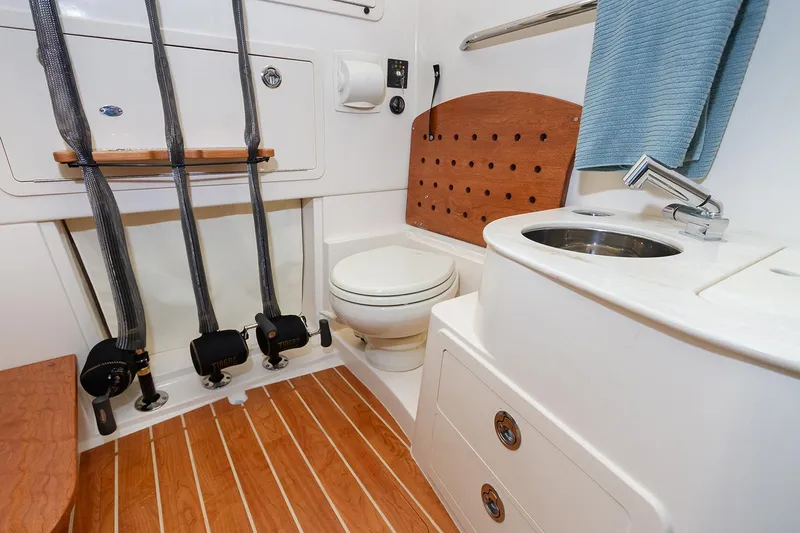 Yacht Photos Pics Manufacturer Provided Image: 2025 Grady-White Canyon 336 boat bathroom with wooden flooring and modern fixtures.