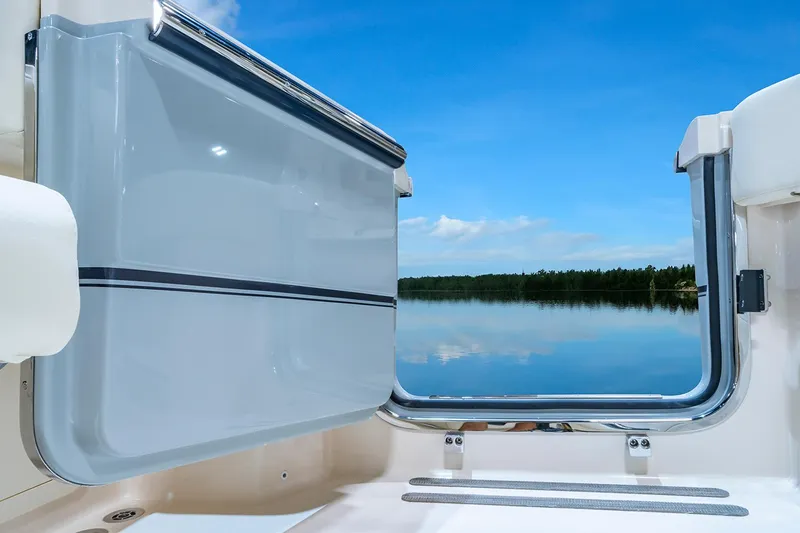  Yacht Photos Pics Manufacturer Provided Image: 2025 Grady-White Canyon 336 boat with open side door, overlooking serene water and blue sky.