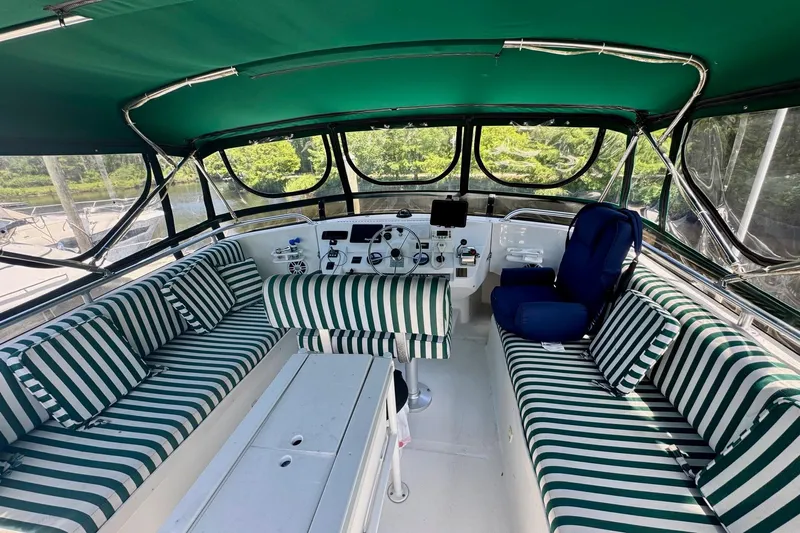 Ripple Yacht Photos Pics Interior of 2000 Mainship 390 Trawler with striped seating and navigation controls.