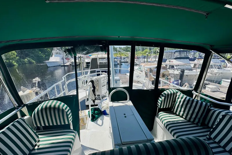 Ripple Yacht Photos Pics Interior view of 2000 Mainship 390 Trawler with striped seating at marina.