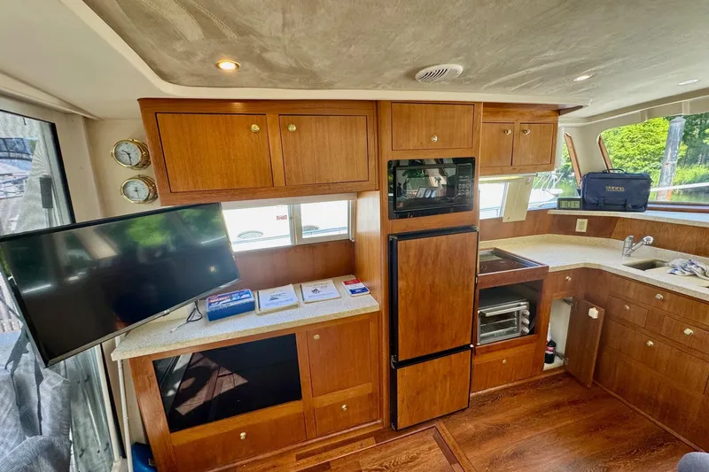 Ripple Yacht Photos Pics Interior of 2000 Mainship 390 Trawler with wooden cabinetry and modern appliances.