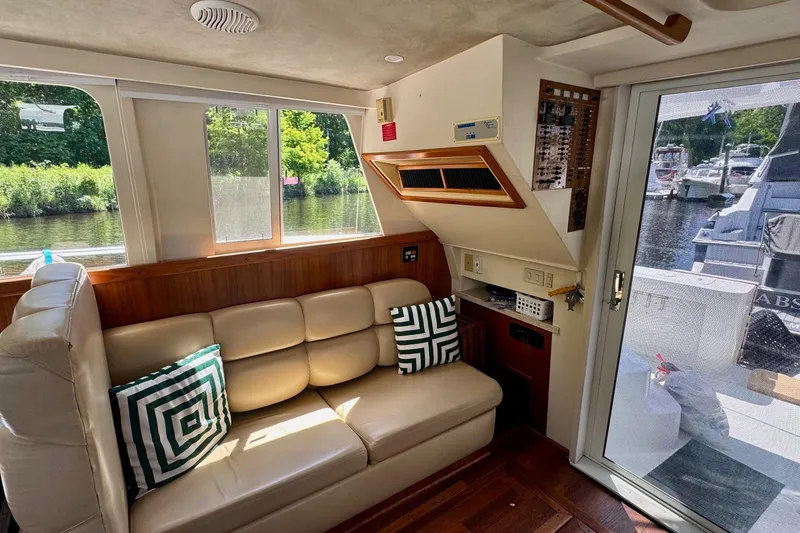Ripple Yacht Photos Pics Interior of 2000 Mainship 390 Trawler with beige seating and geometric pillows.