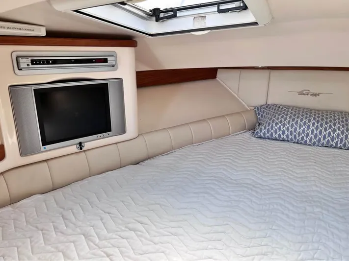  Yacht Photos Pics 2005 Grady-White Express 360 cabin interior with bed, TV, and skylight.