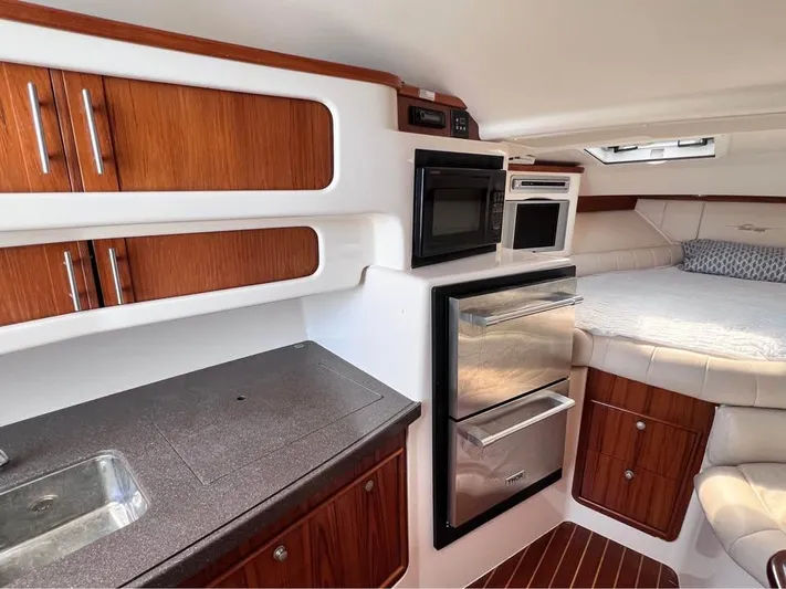  Yacht Photos Pics 2005 Grady-White Express 360 cabin interior with kitchenette and bed.