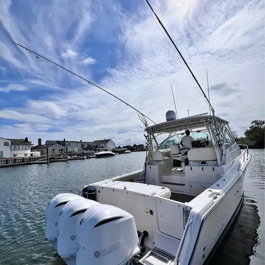  Yacht Photos Pics 2005 Grady-White Express 360 boat on water, clear sky, residential backdrop.