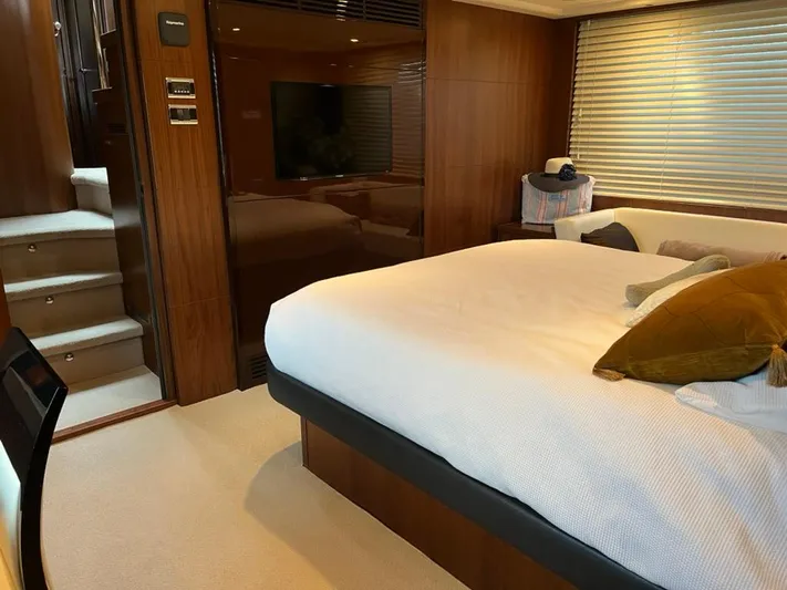  Yacht Photos Pics Luxurious bedroom interior of 2013 Princess 72 Motor Yacht with modern decor and cozy ambiance.