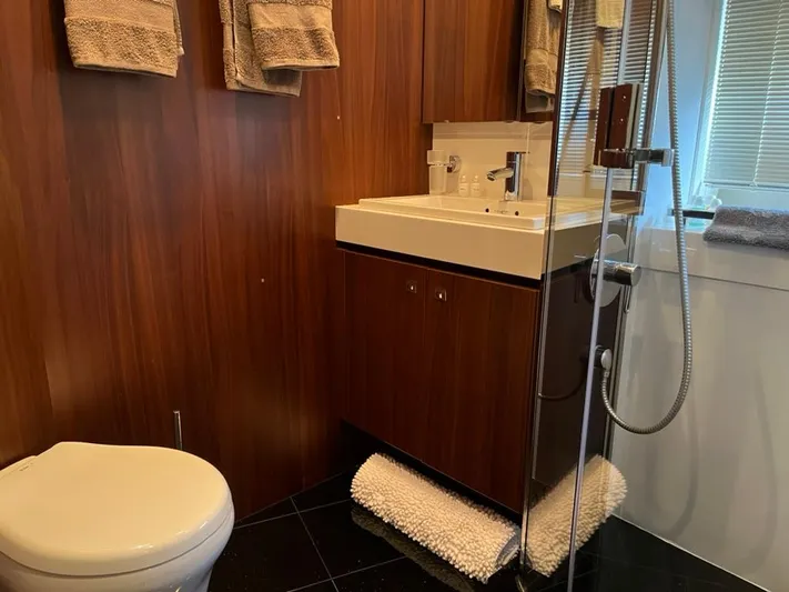  Yacht Photos Pics Luxurious bathroom in 2013 Princess 72 Motor Yacht with wood paneling and modern fixtures.