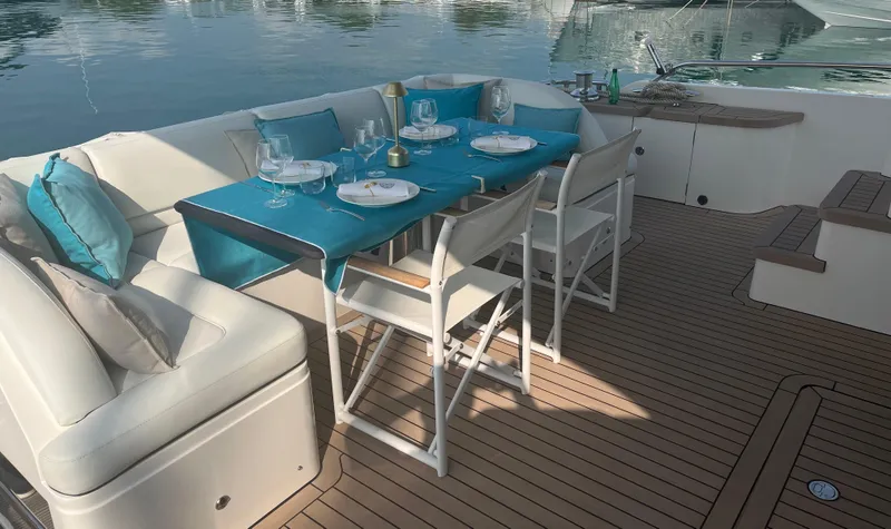  Yacht Photos Pics Luxurious dining setup on 2013 Princess 72 Motor Yacht deck with blue accents.