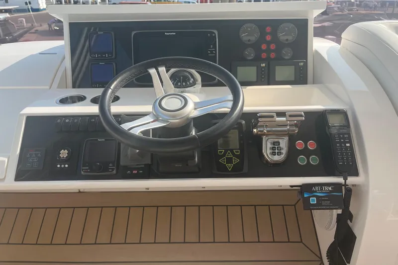  Yacht Photos Pics Control panel of a 2013 Princess 72 Motor Yacht with steering wheel and navigation instruments.