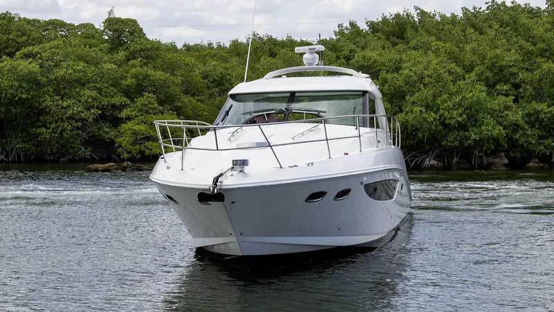  Yacht Photos Pics 2015 Sea Ray 450 Sundancer yacht cruising on a calm waterway.