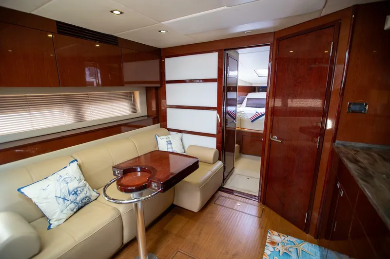  Yacht Photos Pics Luxurious interior of 2015 Sea Ray 450 Sundancer yacht with elegant seating and wooden finishes.