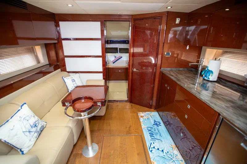  Yacht Photos Pics Luxurious interior of 2015 Sea Ray 450 Sundancer yacht with modern kitchen and seating area.