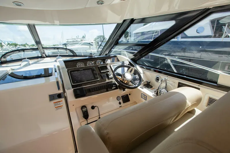  Yacht Photos Pics Helm of 2015 Sea Ray 450 Sundancer yacht with modern controls and leather seating.