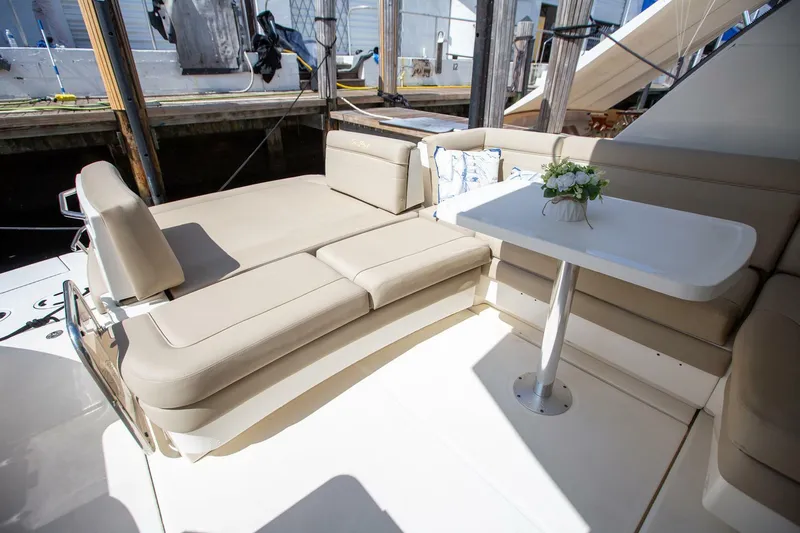  Yacht Photos Pics 2015 Sea Ray 450 Sundancer yacht with beige seating and a white table on deck.