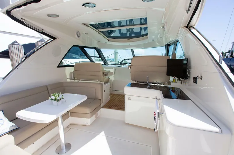  Yacht Photos Pics Interior of 2015 Sea Ray 450 Sundancer yacht with seating, table, and kitchenette.