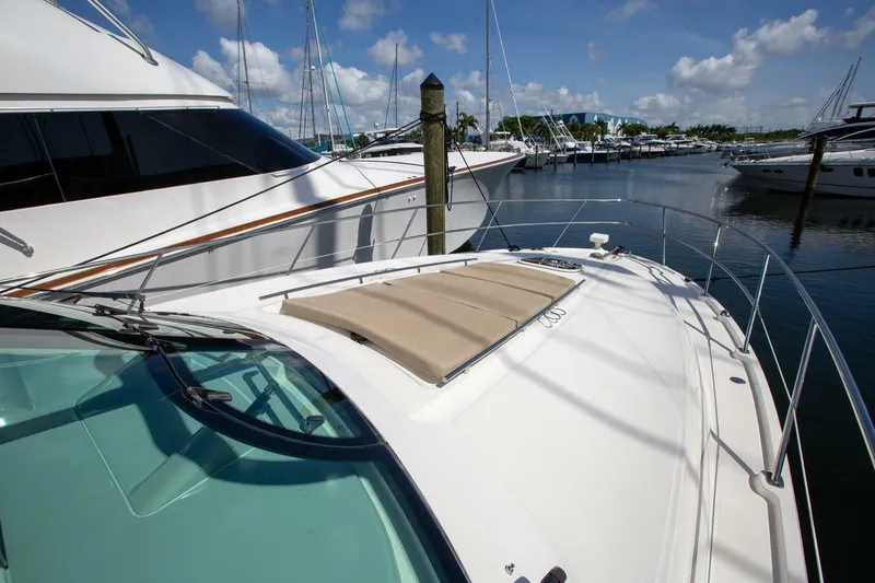  Yacht Photos Pics 2015 Sea Ray 450 Sundancer yacht docked in a marina under a clear blue sky.