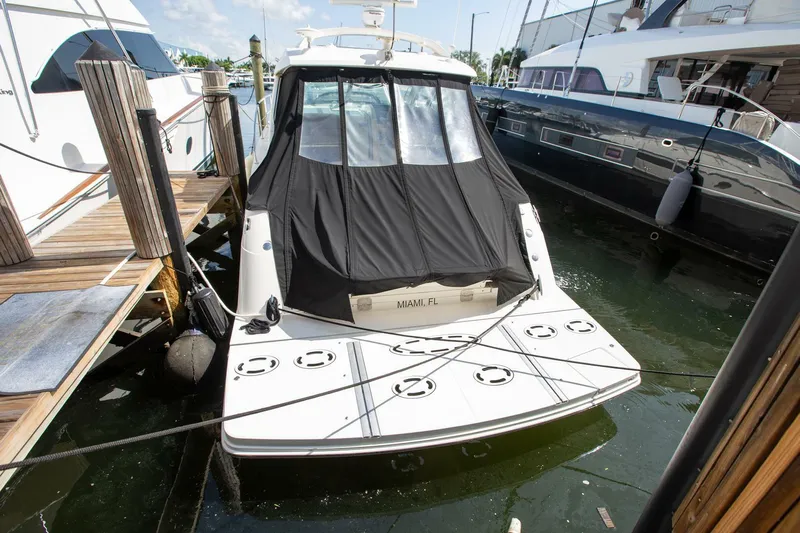  Yacht Photos Pics 2015 Sea Ray 450 Sundancer yacht docked at marina, rear view with black cover.