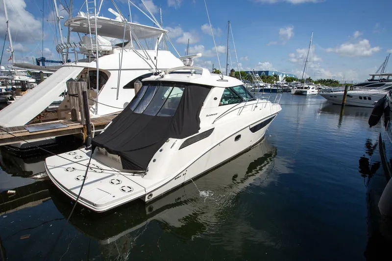  Yacht Photos Pics 2015 Sea Ray 450 Sundancer yacht docked in marina under clear blue sky.