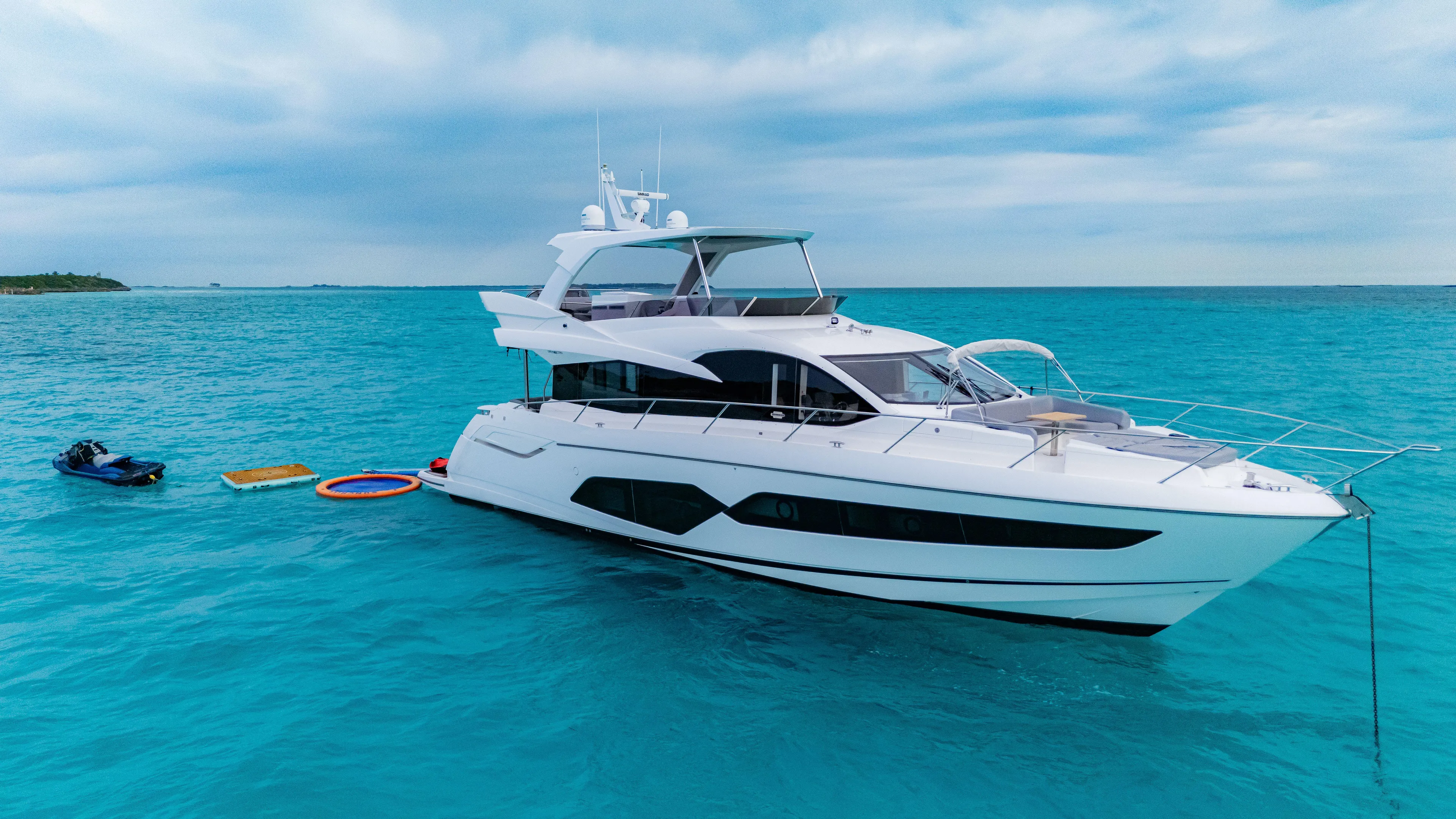 O Legasea Yacht Photos Pics 2018 Sunseeker Manhattan 66 yacht on turquoise water, with clear skies.