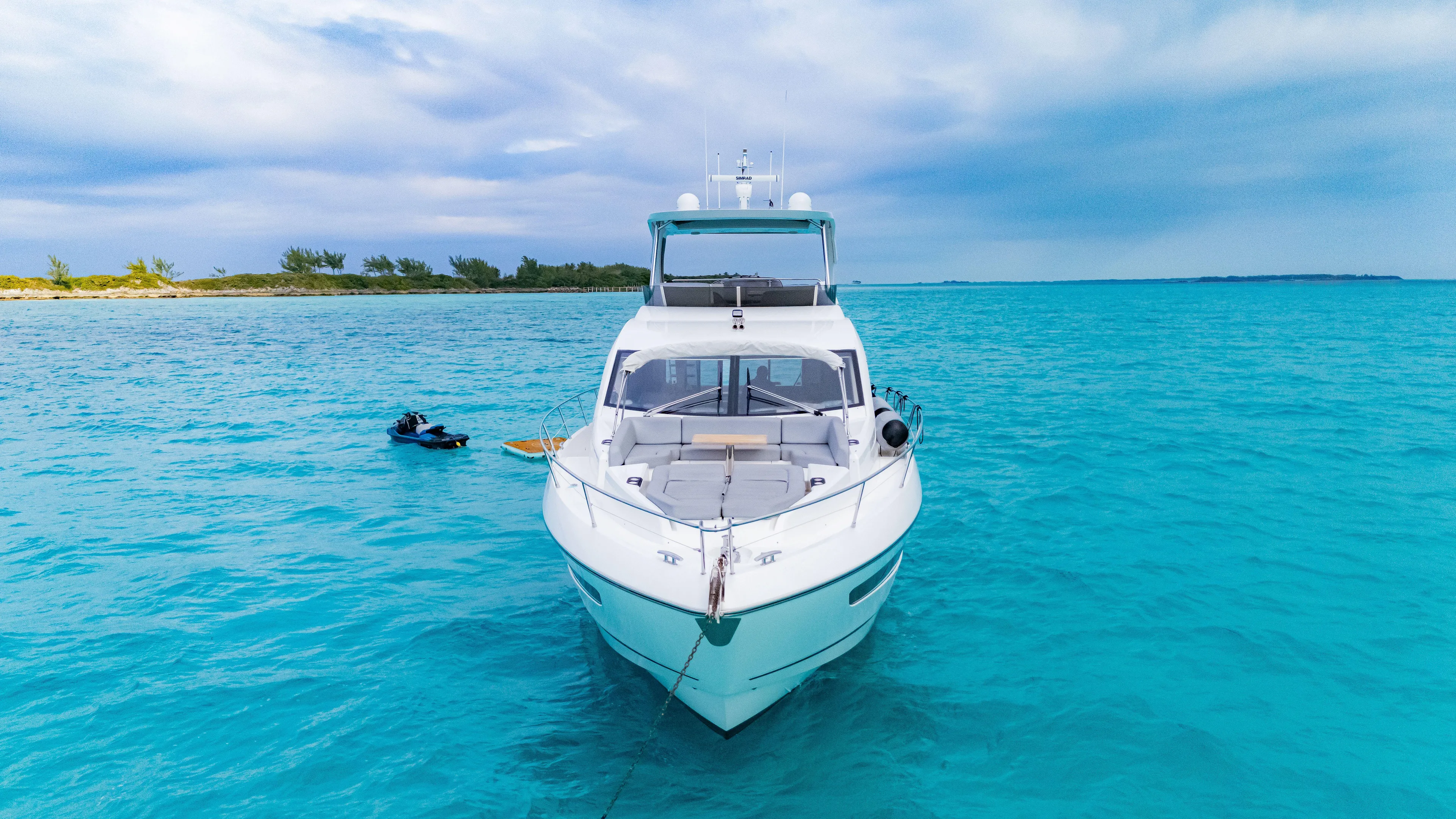 O Legasea Yacht Photos Pics 2018 Sunseeker Manhattan 66 yacht on turquoise water, clear sky background.