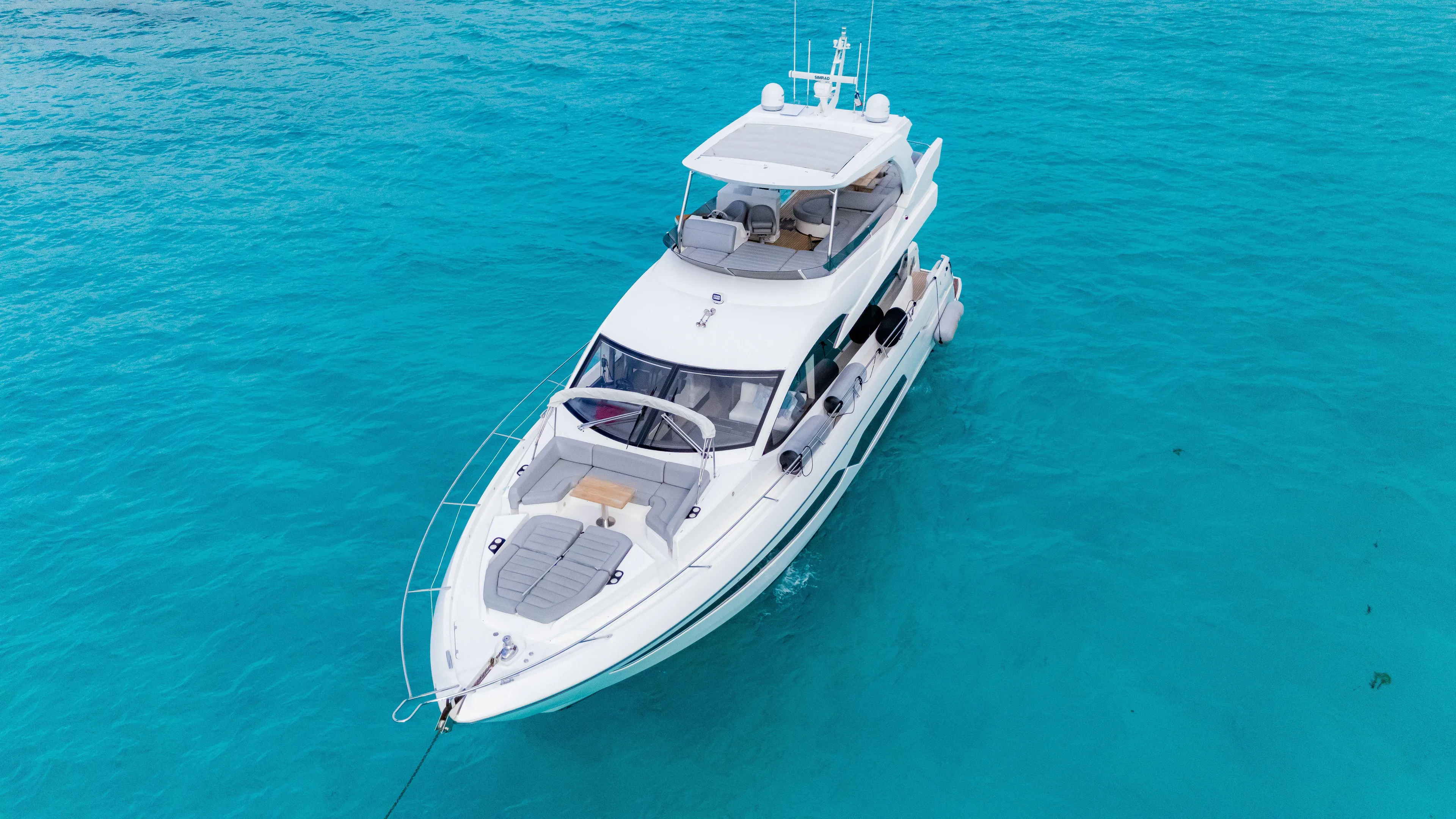 O Legasea Yacht Photos Pics 2018 Sunseeker Manhattan 66 yacht on clear turquoise water.