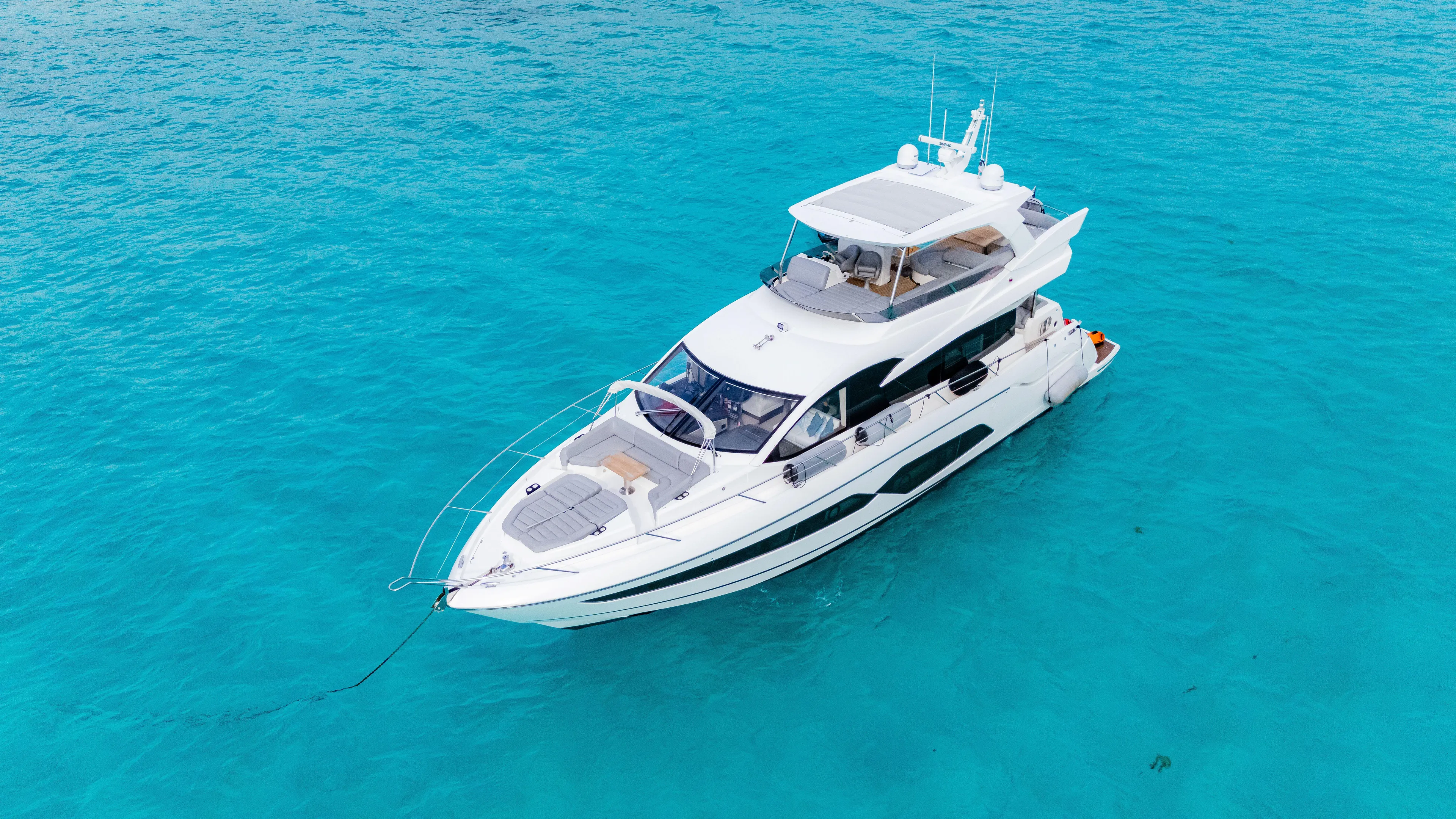 O Legasea Yacht Photos Pics 2018 Sunseeker Manhattan 66 yacht on clear turquoise water.