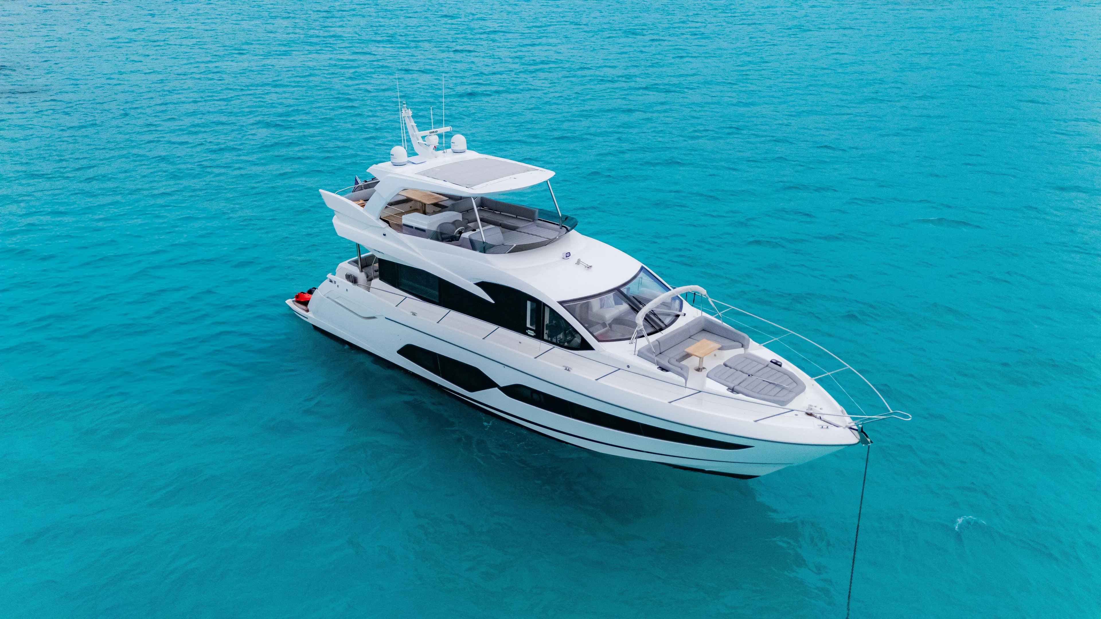 O Legasea Yacht Photos Pics 2018 Sunseeker Manhattan 66 yacht on clear turquoise water.