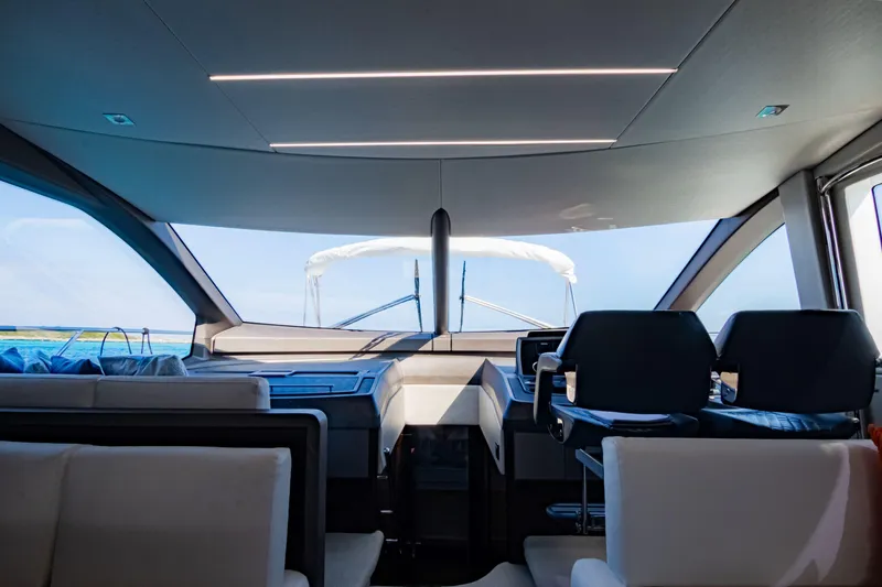 O Legasea Yacht Photos Pics Interior view of 2018 Sunseeker Manhattan 66 yacht cockpit with modern seating and controls.