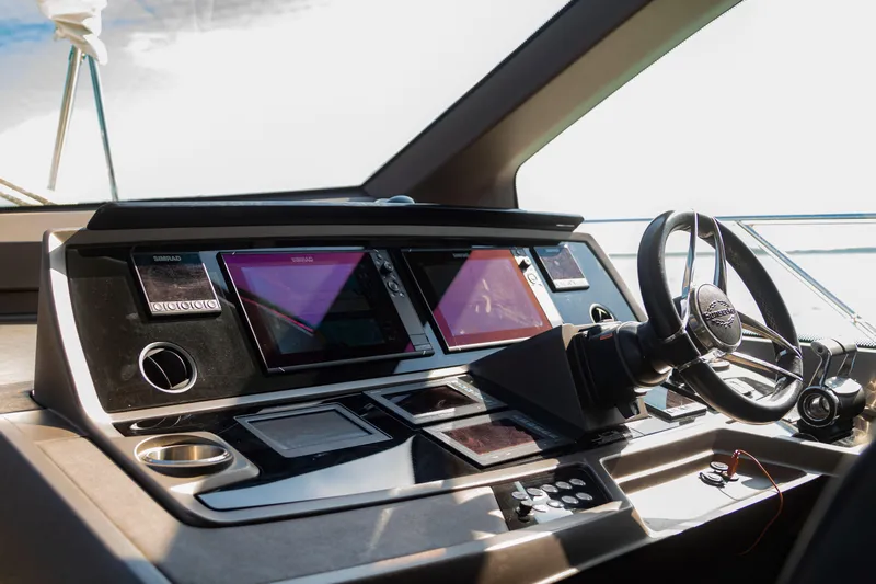 O Legasea Yacht Photos Pics Cockpit of 2018 Sunseeker Manhattan 66 yacht with modern navigation equipment and steering wheel.