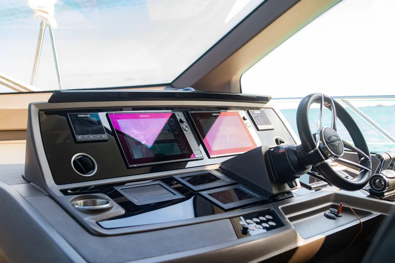 O Legasea Yacht Photos Pics Control panel of a 2018 Sunseeker Manhattan 66 yacht with modern navigation displays.