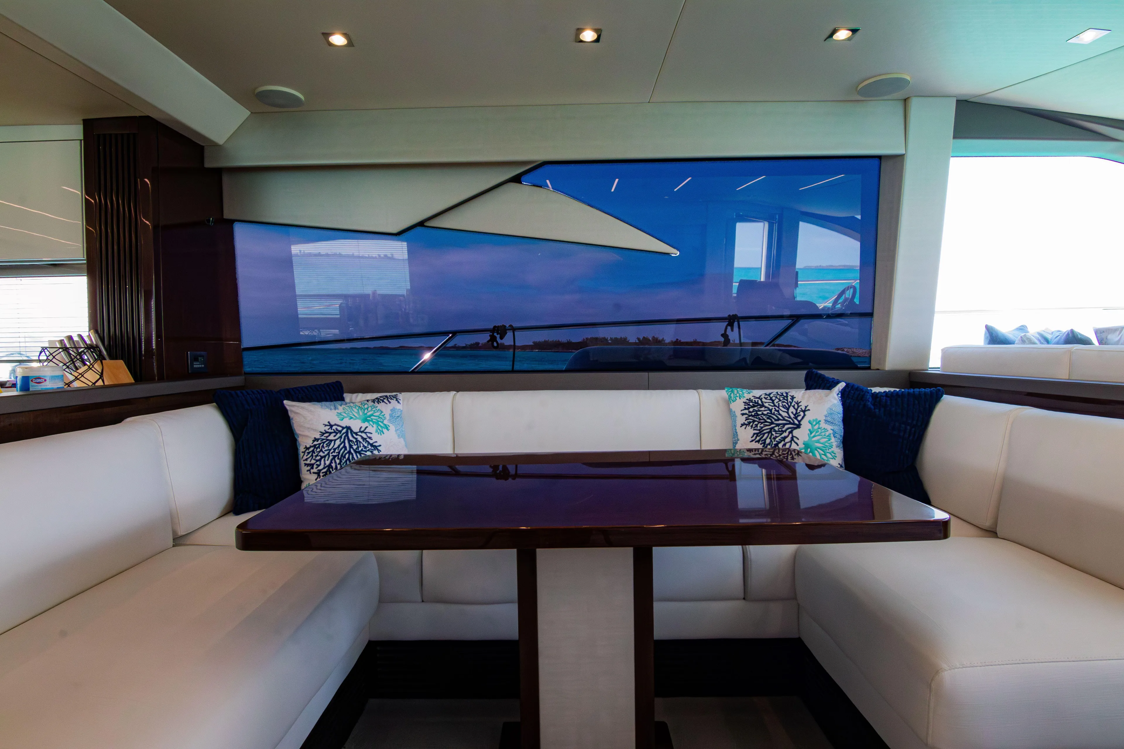 O Legasea Yacht Photos Pics Luxurious interior of 2018 Sunseeker Manhattan 66 yacht with elegant seating and table.