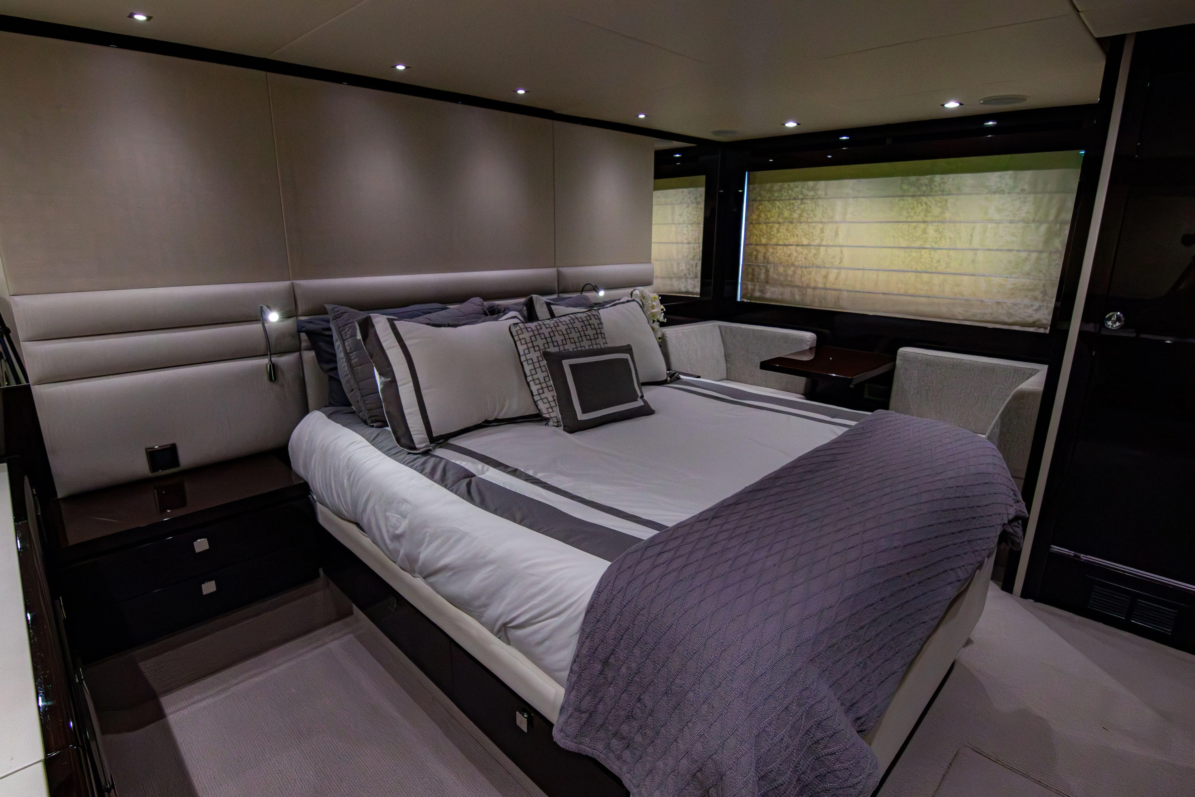 O Legasea Yacht Photos Pics Luxurious bedroom interior of 2018 Sunseeker Manhattan 66 yacht, featuring elegant bedding and modern design.