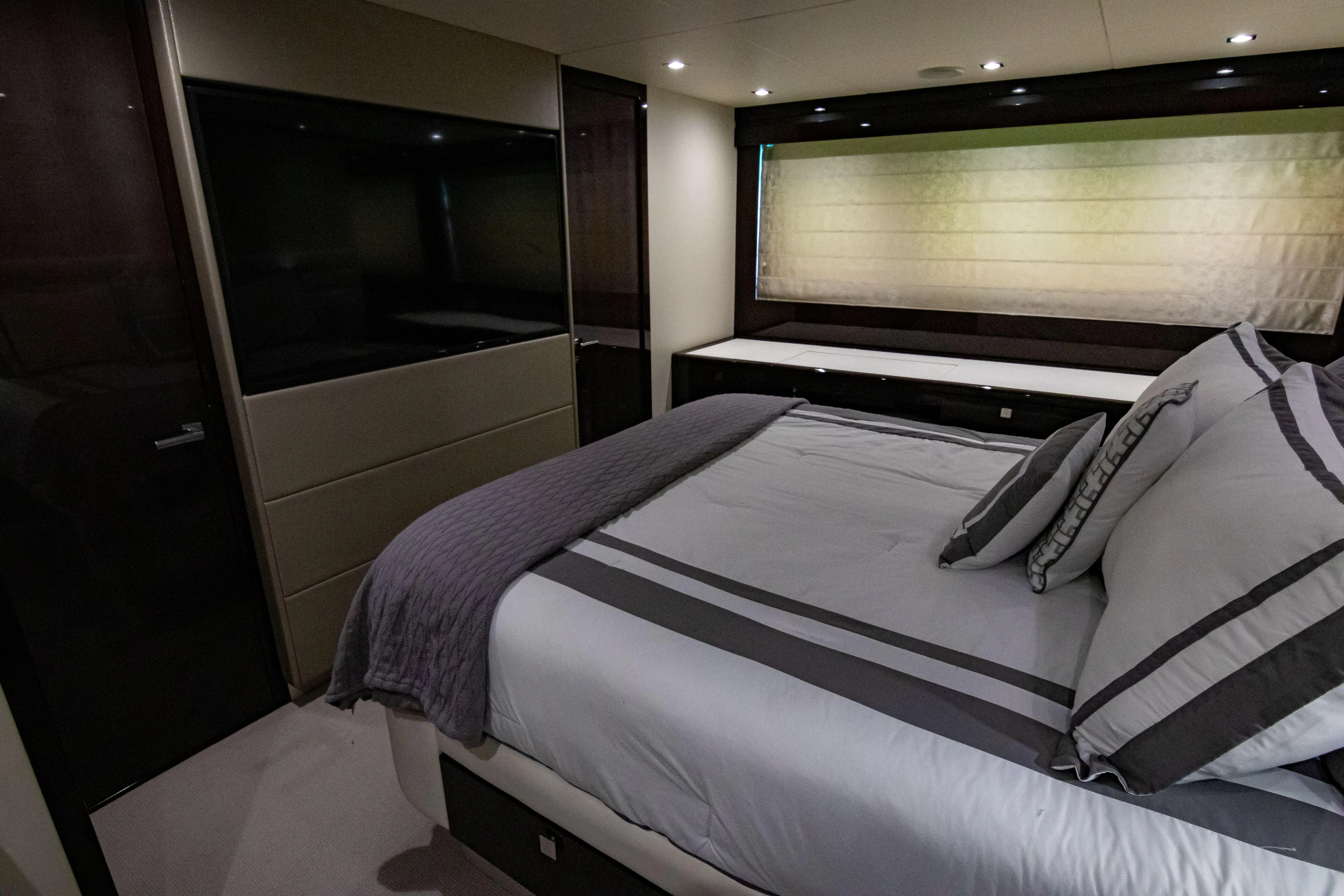 O Legasea Yacht Photos Pics Luxurious bedroom interior of 2018 Sunseeker Manhattan 66 yacht, featuring elegant bedding and modern design.