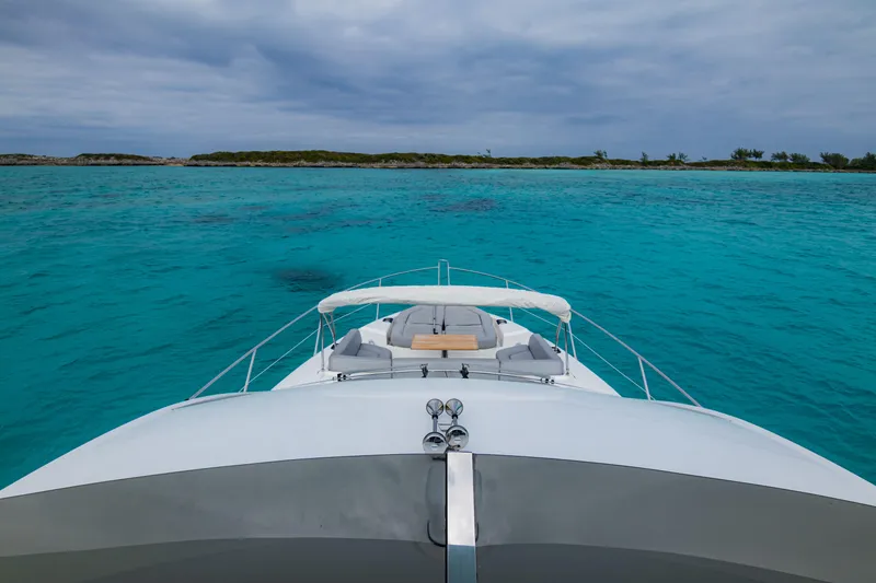 O Legasea Yacht Photos Pics Sunseeker Manhattan 66 yacht cruising in clear turquoise waters, 2018 model.