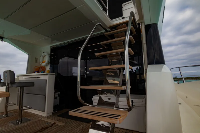 O Legasea Yacht Photos Pics Interior view of 2018 Sunseeker Manhattan 66 yacht with wooden stairs and modern design.