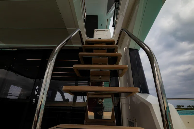 O Legasea Yacht Photos Pics Staircase on 2018 Sunseeker Manhattan 66 yacht under cloudy sky.