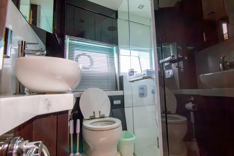 O Legasea Yacht Photos Pics Bathroom interior of 2018 Sunseeker Manhattan 66 yacht, featuring modern fixtures and glass shower.