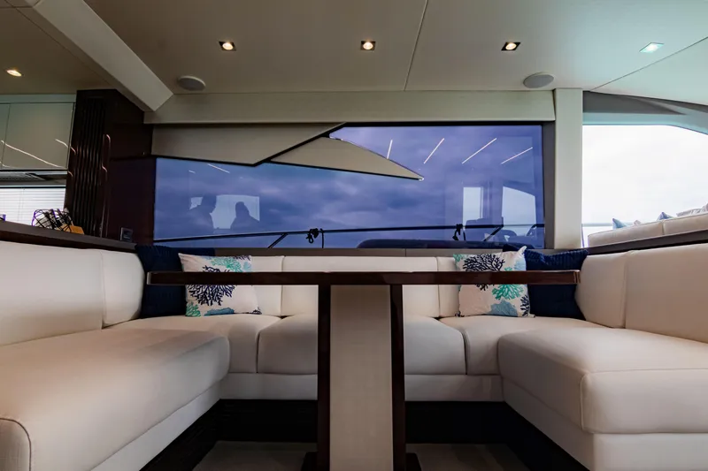 O Legasea Yacht Photos Pics Luxurious interior of 2018 Sunseeker Manhattan 66 yacht with plush seating and large windows.
