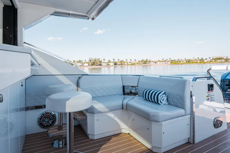 No Name Yacht Photos Pics Luxurious seating area on 2022 Formula 500 Super Sport Crossover yacht, overlooking serene waters.