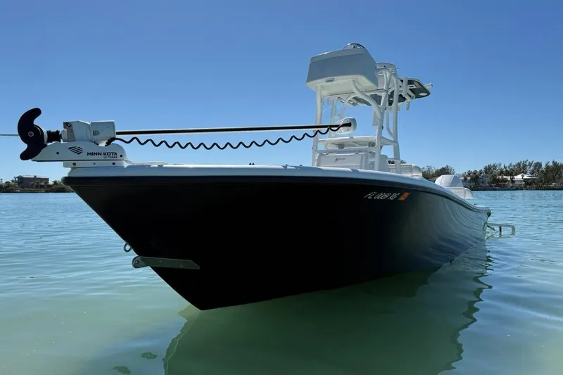  Yacht Photos Pics 2017 Yellowfin 26 Hybrid boat on calm water, featuring Minn Kota trolling motor.