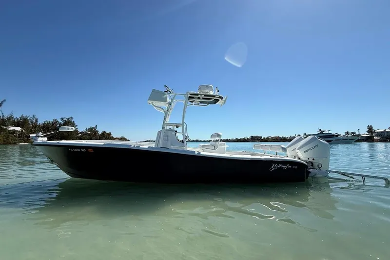  Yacht Photos Pics 2017 Yellowfin 26 Hybrid boat on calm water under clear blue sky.