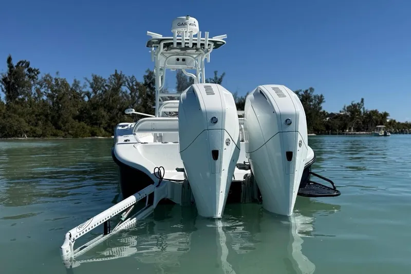  Yacht Photos Pics 2017 Yellowfin 26 Hybrid boat with dual engines on calm water.