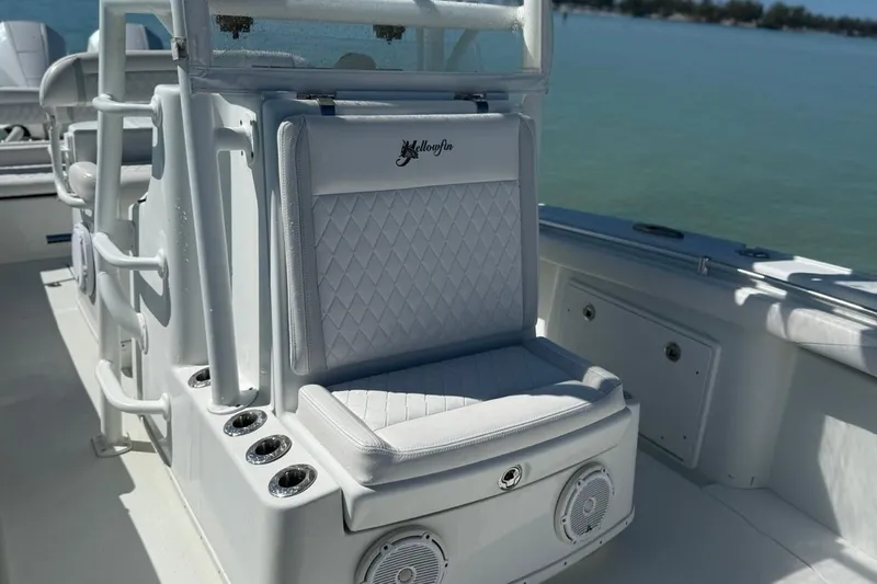  Yacht Photos Pics 2017 Yellowfin 26 Hybrid boat interior with cushioned seating and rod holders.