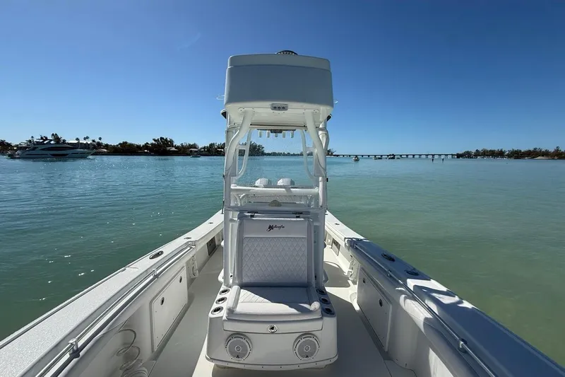  Yacht Photos Pics 2017 Yellowfin 26 Hybrid boat on calm water with clear blue sky.